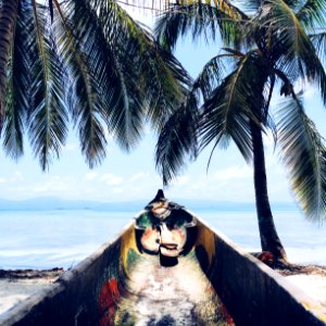 gray canoe in front of ocean photo