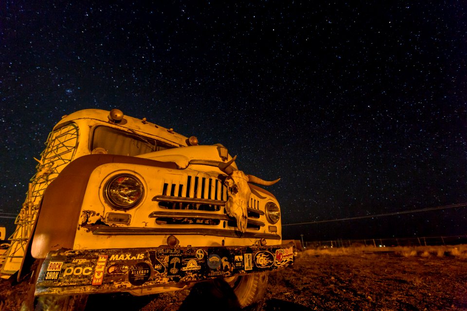 photo of white and brown bus with stars during nighttime