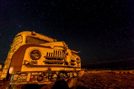 photo of white and brown bus with stars during nighttime