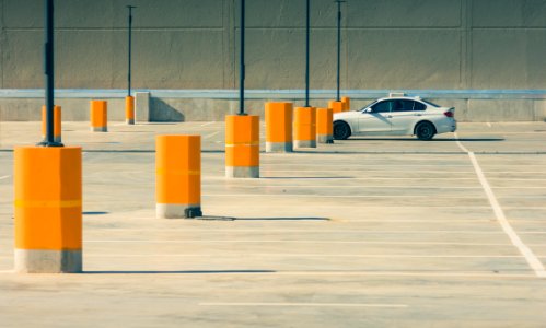 white sedan on parking lot during day time