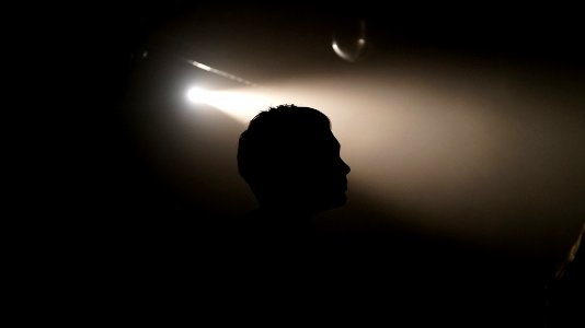 silhouette of person inside dim lighted room