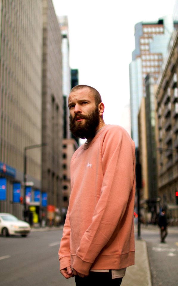 man in pink long-sleeved shirt standing outdoors