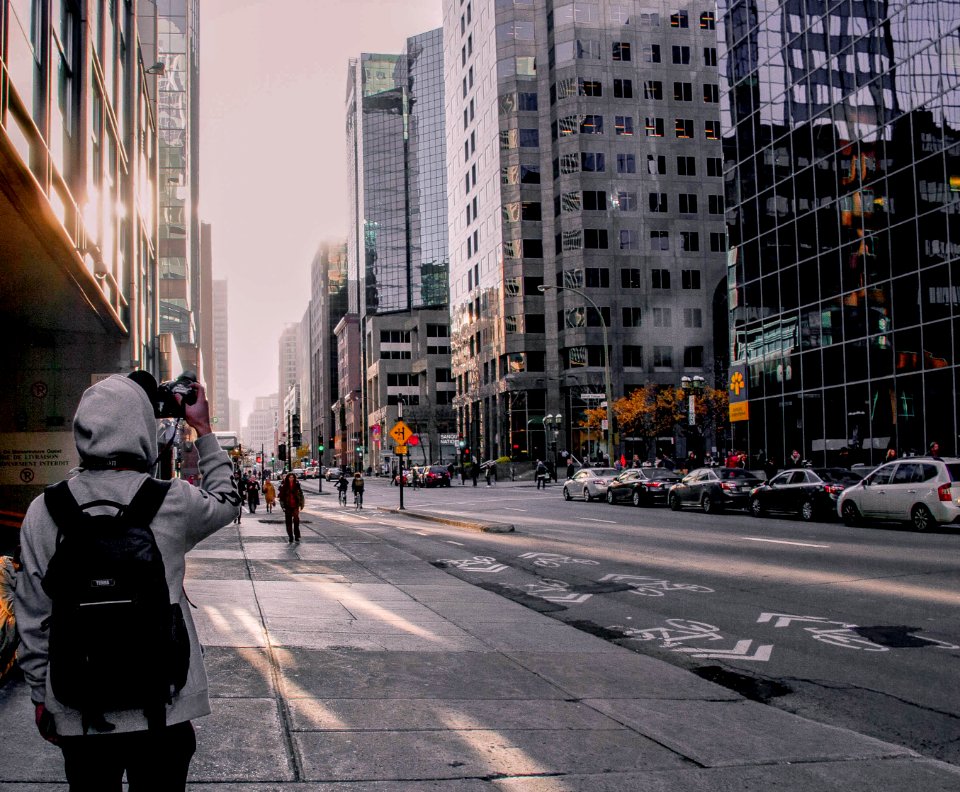 grayscale photography of person standing beside road during daytime photo