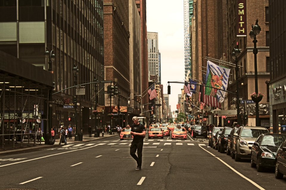 man standing in road during daytime