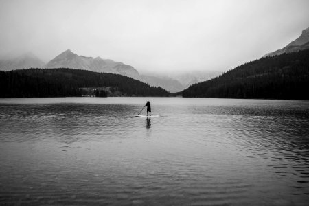 silhouette of person on body of water photo