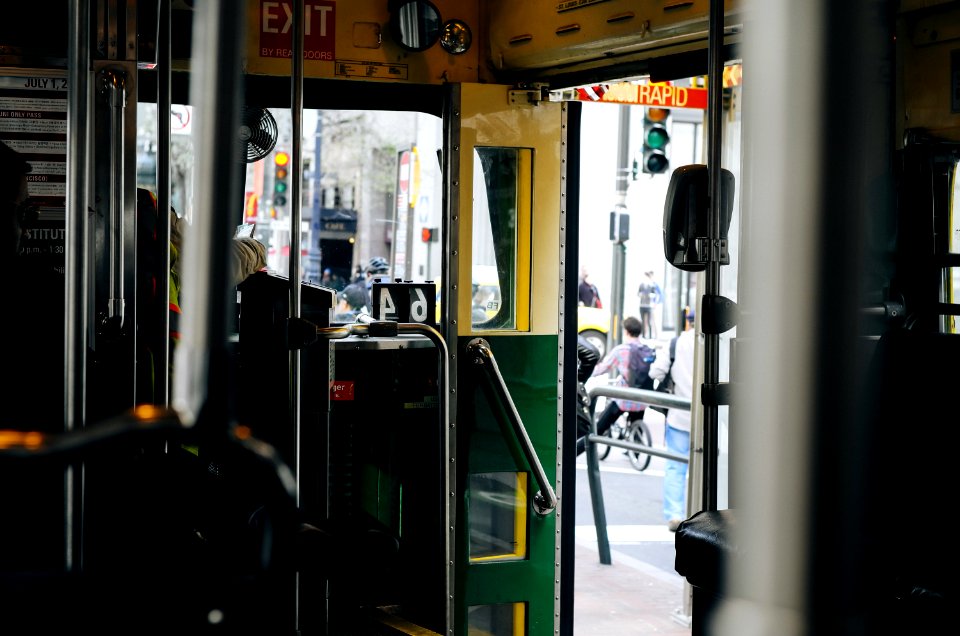 selective focus photograph of green and yellow door of tram