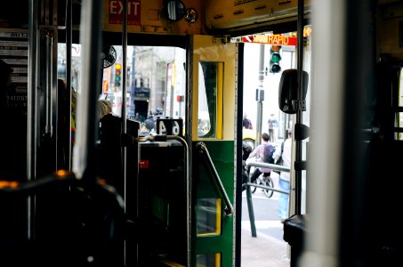 selective focus photograph of green and yellow door of tram