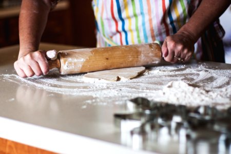 person holding rolling pin photo