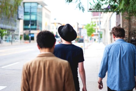 three men walking along the street