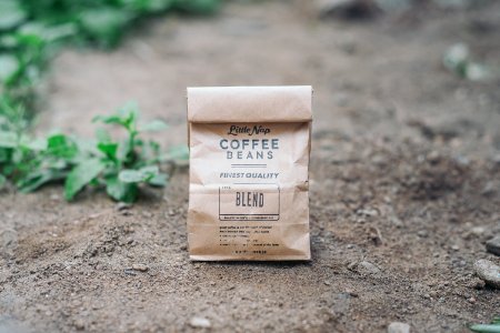 Coffee Beans blend paper bag on ground photo