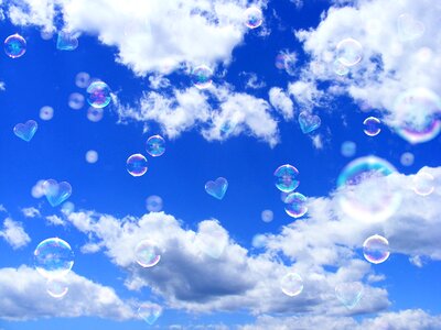 Soap bubbles heart blue sky photo