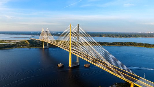 aerial photography of yellow bridge surrounded by body of water photo