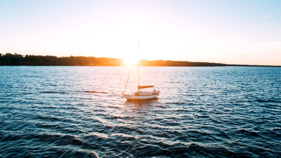 white sailing boat on body of water photo