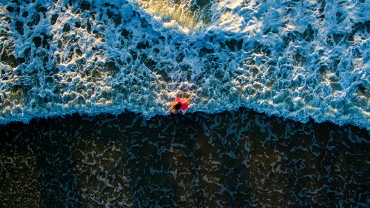 aerial photo of woman standing on shore