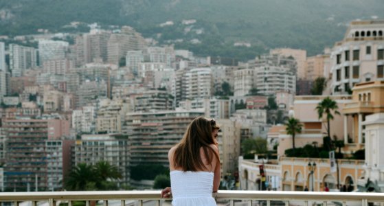 woman standing beside railings looking on her right photo