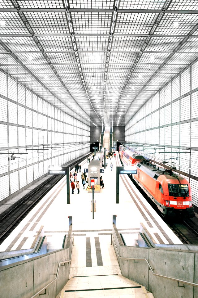 people standing in front of red train photo