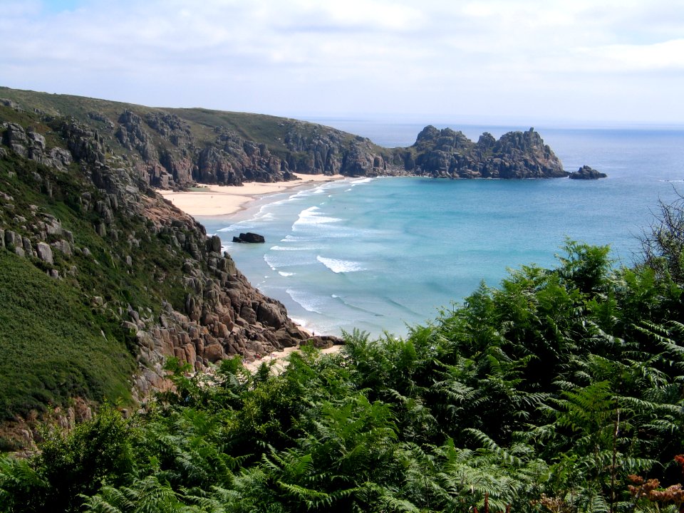 seashore near mountain during daytime