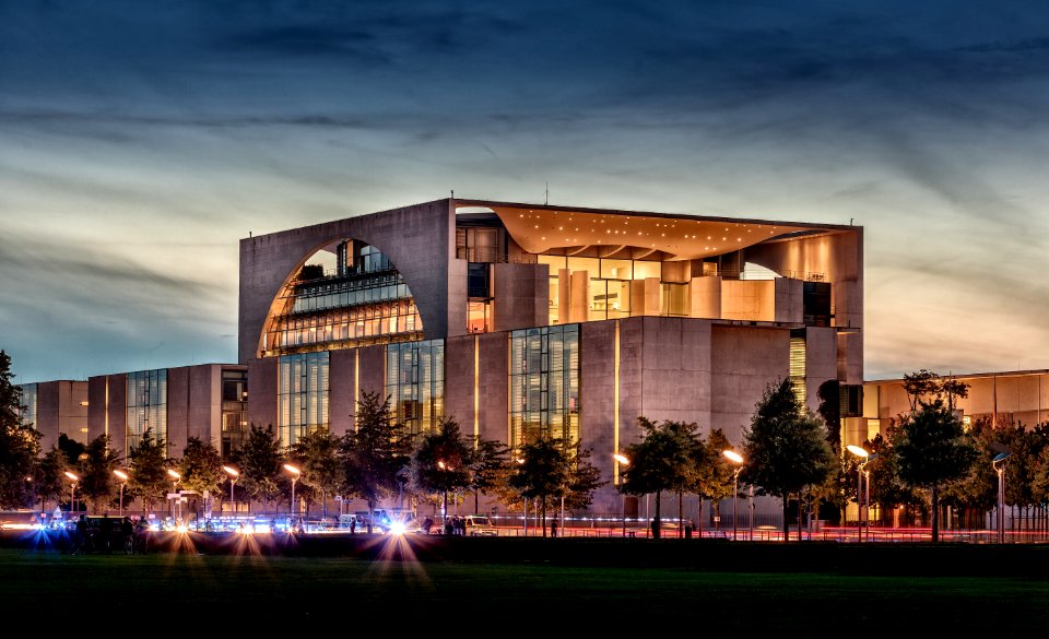 lighted concrete building under gray skies