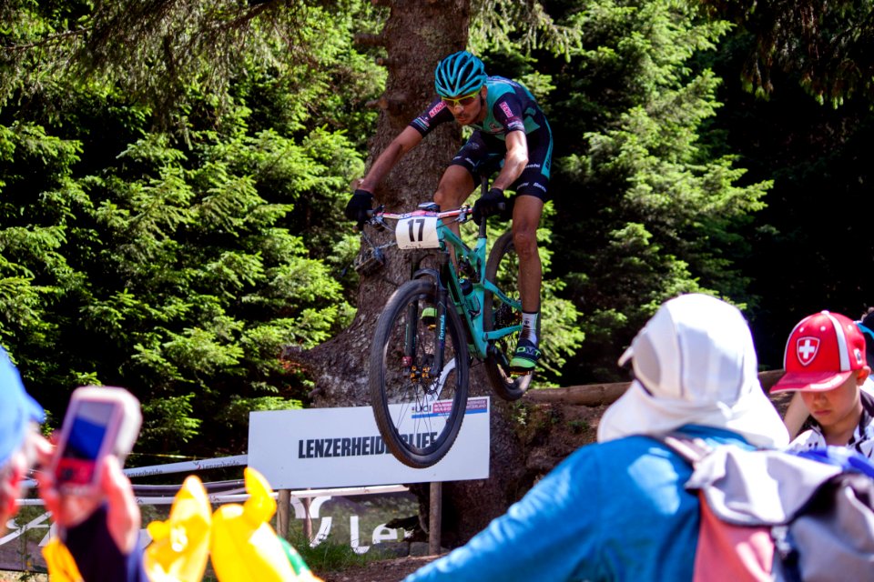 cyclist riding mountain bike jumping over obstackle