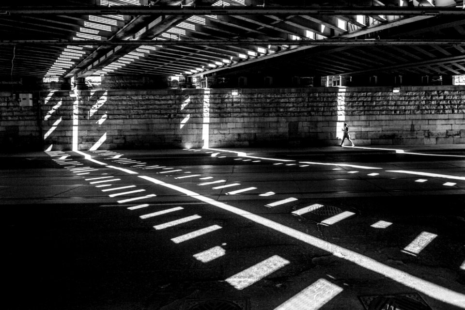 grayscale photography of man walking on road