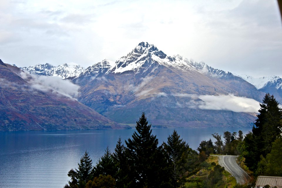 body of water near mountain at daytime