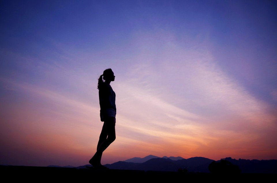 woman standing under blue sky