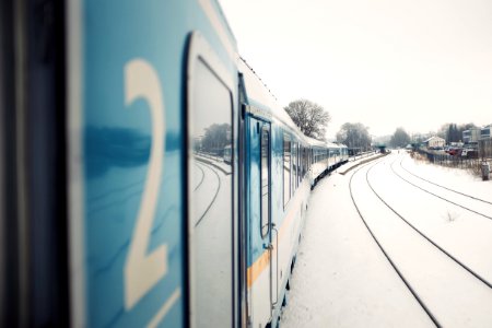blue train beside houses