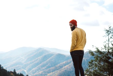 man standing on top of hill photo