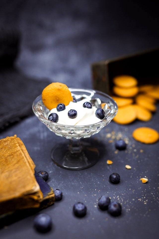 shallow focus photography of yoghurt in glass with blueberries on top