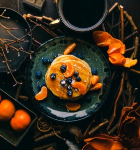 pancakes with orange and blueberry on plate photo