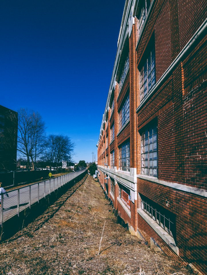 brown brick building under blue sky during daytime