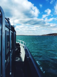 white and black boat on sea during daytime photo