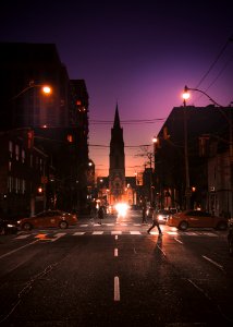 People crossing the street at night.