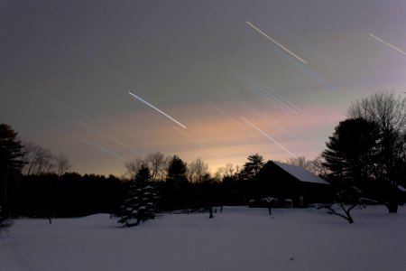 snow-covered house surrounded by trees during nighttime photo