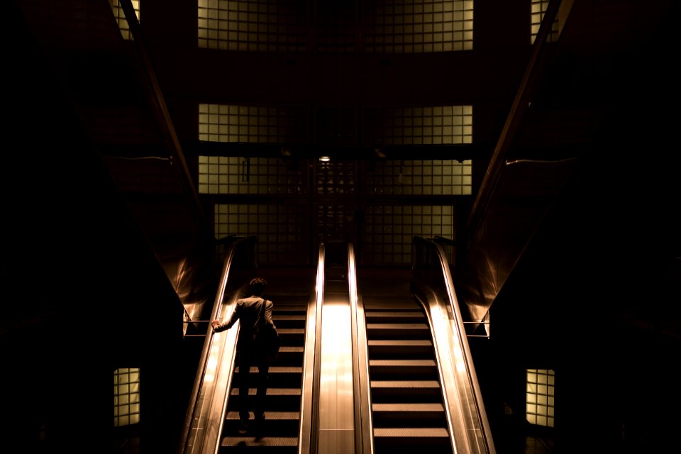 woman standing on escalator photo