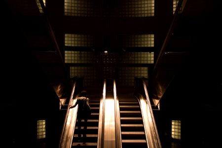 woman standing on escalator