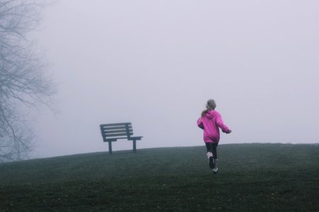 girl running near black bench photo