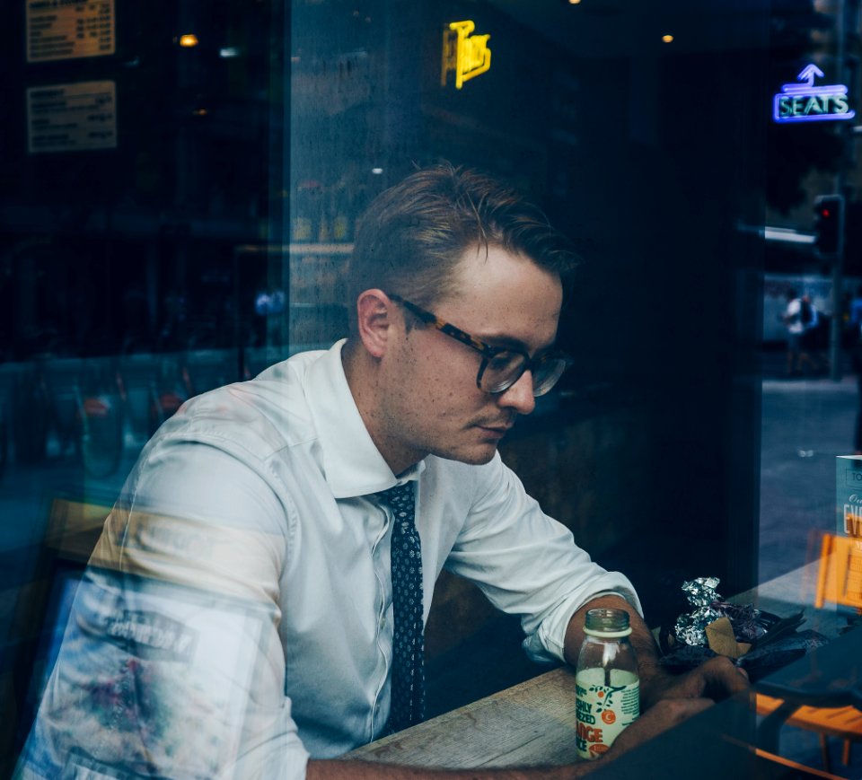man wearing sunglasses inside cafe