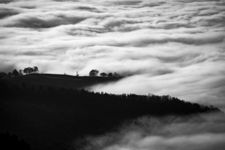 photo of mountain surrounded with sea of clouds