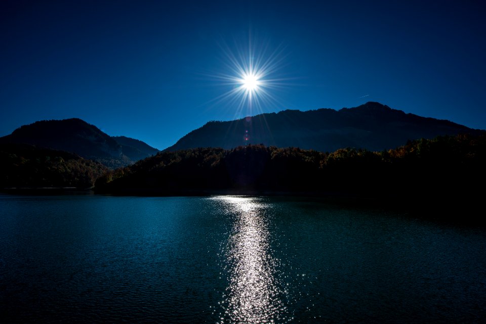 brown mountain near body of water