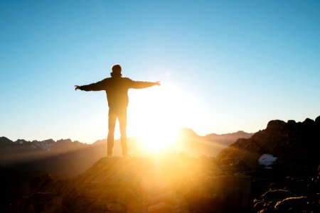 person standing on hill photo