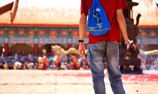 man wearing red shirt holding video camera photo