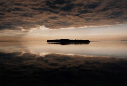 island in the middle of body of water photo