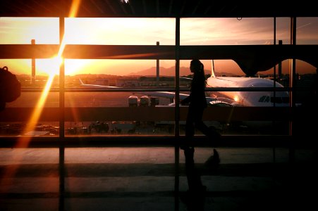 silhouette of person walking beside airplane