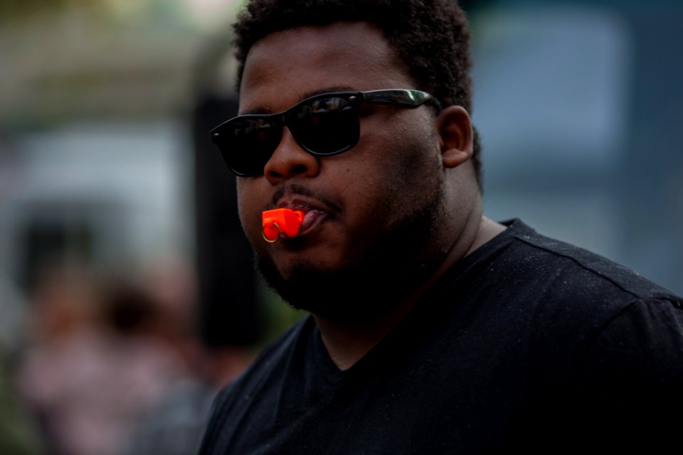 man in black crew neck shirt wearing black sunglasses
