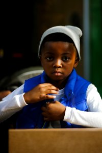 boy in blue and white long sleeve shirt wearing white and black knit cap photo