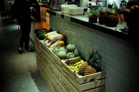 fruits in crates beside wall photo