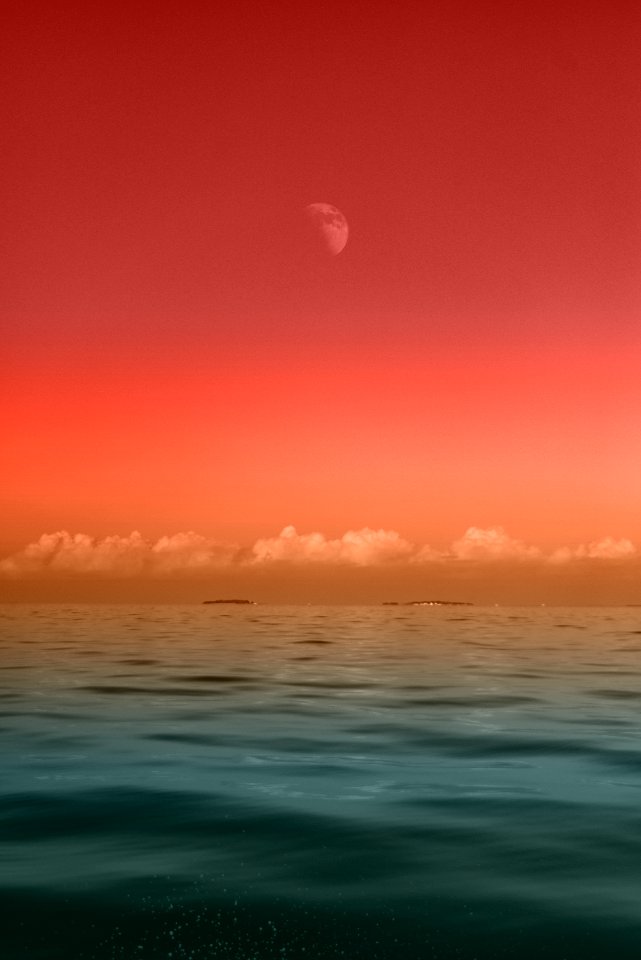 seascape photography of sea under half-moon