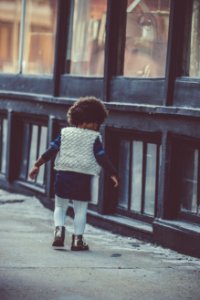 A kid walking down the street. photo