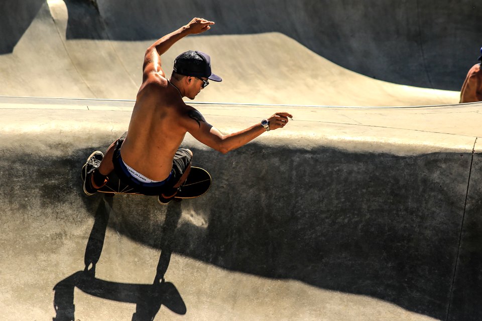 man riding skateboard doing trick outdoor